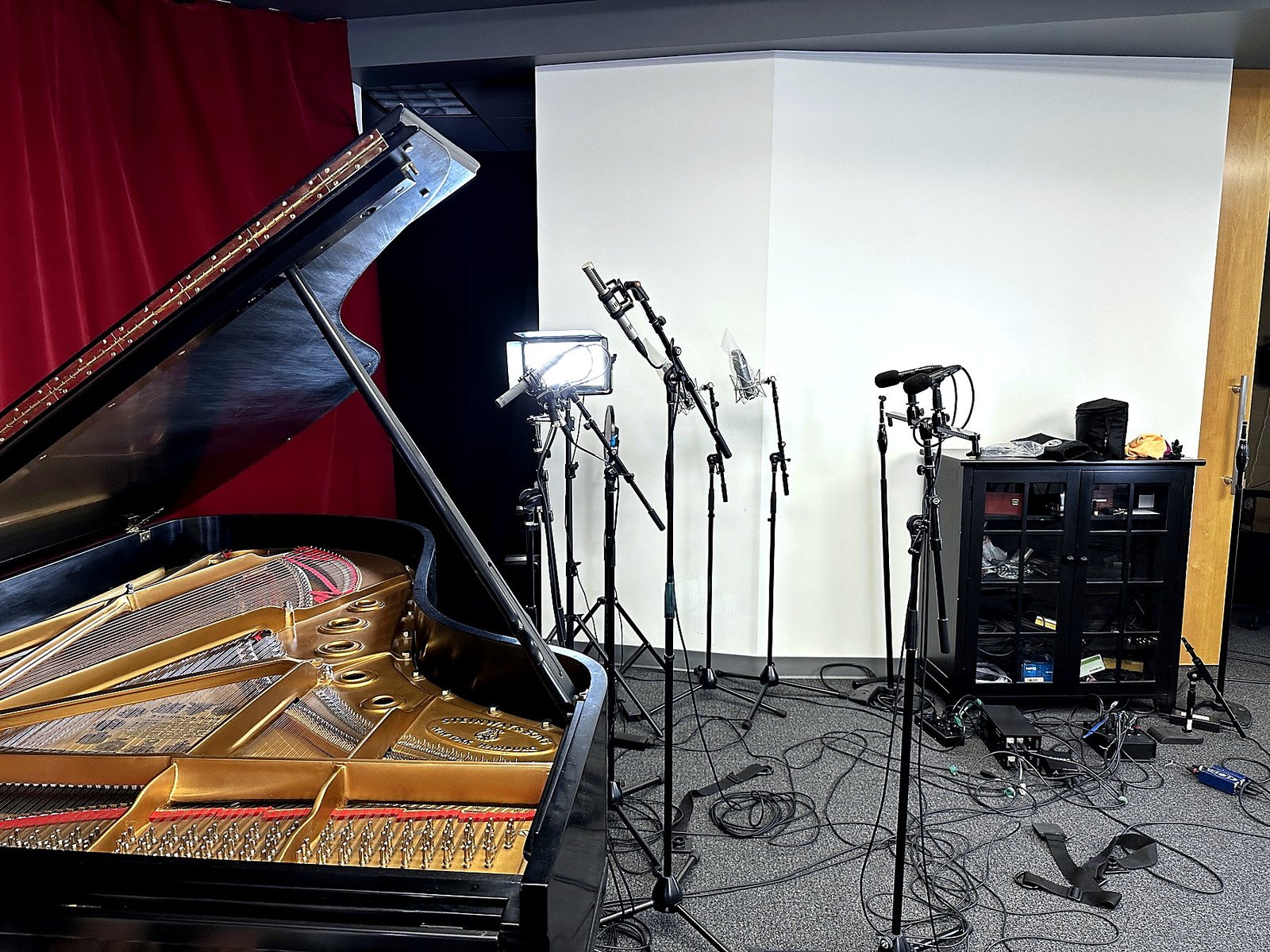 Microphones, grand piano and recording equipment in the studio