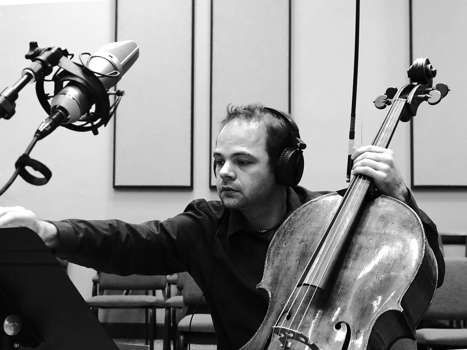 László Mező recording cello with headphones and a studio microphone